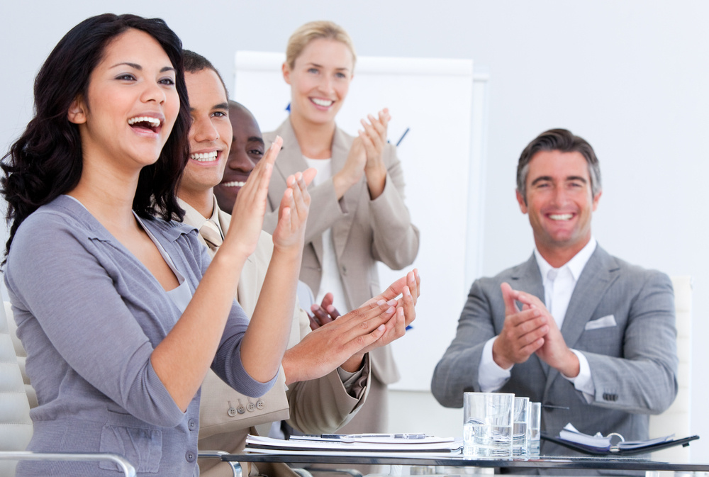 Cheerful business people applauding in a meeting. Business concept.